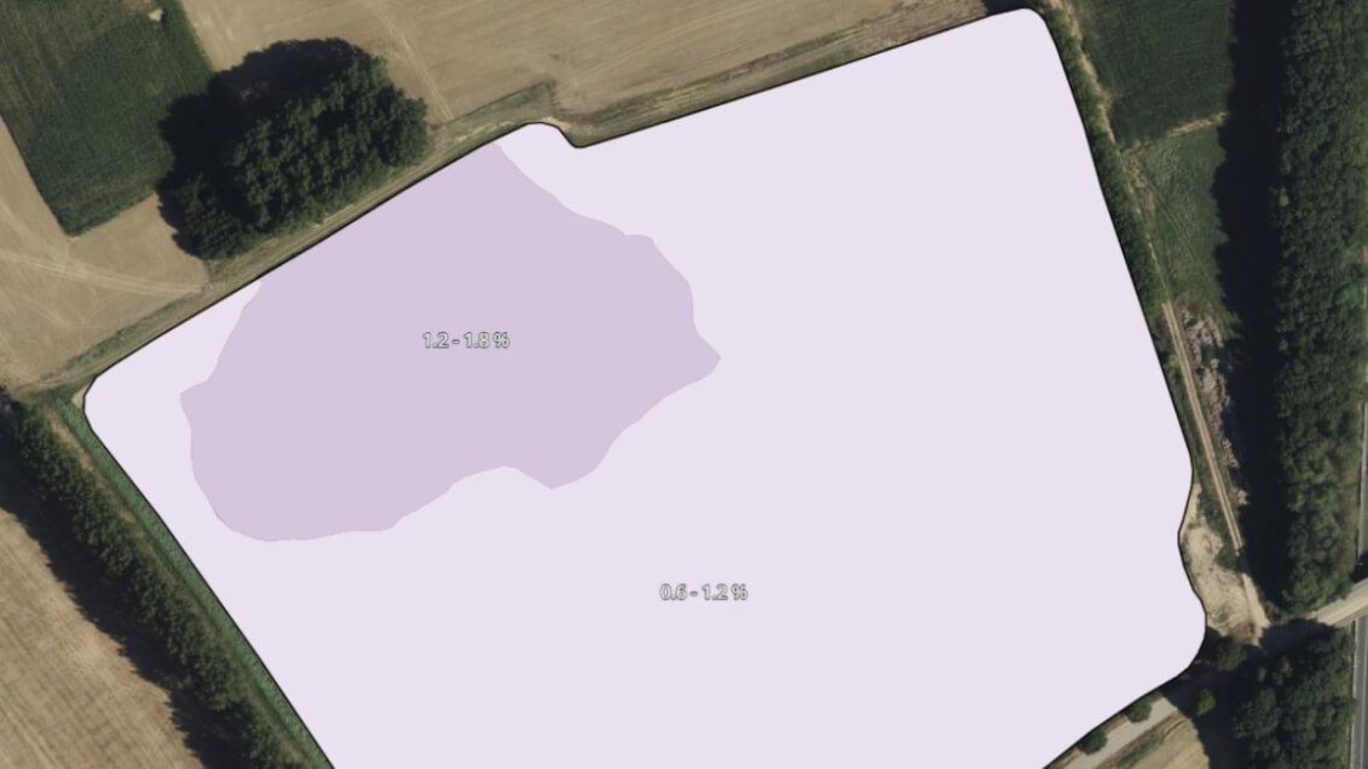 Aerial field map with white overlay showing measurement zones against satellite imagery of agricultural land.