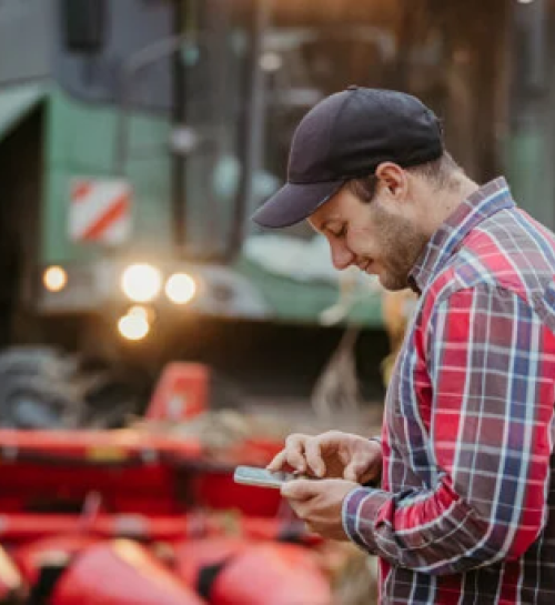 A person in a hat looking at his phone