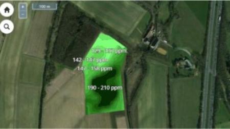 Aerial satellite or drone view of agricultural fields with digital overlay showing soil nutrient levels or measurements in ppm (parts per million) displayed in green boxes across different sections of the field.